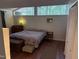 Cozy bedroom with unique window design, a chest of drawers, and ample natural light at 5836 Sandstone Dr, Durham, NC 27713