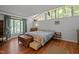 Bright bedroom with unique window design and hardwood floors at 5836 Sandstone Dr, Durham, NC 27713
