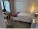 Serene bedroom featuring a single bed, desk, and built-in closets with natural light at 5836 Sandstone Dr, Durham, NC 27713