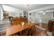Dining area showcasing wood floors and a connection to a cozy living space at 5836 Sandstone Dr, Durham, NC 27713