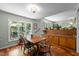 Dining room featuring hardwood floors, built-in buffet and a view to the backyard at 5836 Sandstone Dr, Durham, NC 27713