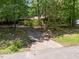 View of the tree-lined driveway up to the house at 5836 Sandstone Dr, Durham, NC 27713