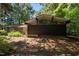 Exterior shot of modern architecture with large windows, stone siding, and woodland surroundings at 5836 Sandstone Dr, Durham, NC 27713