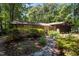 Beautiful stone home with mature landscaping, trees, and a stone walkway to the front entrance at 5836 Sandstone Dr, Durham, NC 27713