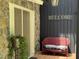 Welcoming front porch featuring a red wicker bench and a 'Welcome' sign at 5836 Sandstone Dr, Durham, NC 27713