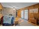 Living room featuring wood paneling, a stone fireplace, and access to the outside at 5836 Sandstone Dr, Durham, NC 27713