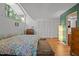 Bright main bedroom with hardwood floors, three closets, and large horizontal window at 5836 Sandstone Dr, Durham, NC 27713