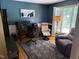 Well-lit home office with a desk, comfortable chairs, and a calming blue wall at 5836 Sandstone Dr, Durham, NC 27713