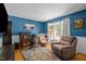 Office space with blue walls, a work desk, and a comfortable recliner chair at 5836 Sandstone Dr, Durham, NC 27713