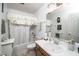 Bathroom with a bright vanity area, a single sink, and a shower-tub combination with a floral curtain, for daily convenience at 6008 River Lake Cir, Raleigh, NC 27604