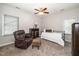 Cozy bedroom featuring a comfortable recliner, ceiling fan, and a single bed, creating a relaxing and inviting atmosphere at 6008 River Lake Cir, Raleigh, NC 27604
