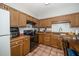 Functional kitchen with wood cabinets, tiled backsplash, and updated appliances for cooking convenience at 6008 River Lake Cir, Raleigh, NC 27604