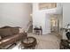 View of the living room with staircase, neutral walls, and plush carpeting, flowing to the hallway and featuring a cozy seating area at 6008 River Lake Cir, Raleigh, NC 27604