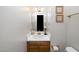 Compact powder room features vanity with sink and a decorative mirror at 6008 River Lake Cir, Raleigh, NC 27604