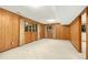 Basement space featuring paneled walls, carpet, and two windows at 623 Totten Pl, Chapel Hill, NC 27514