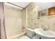 Cozy bathroom featuring wallpaper, a shower/tub combination, toilet and a sink with vanity mirror at 623 Totten Pl, Chapel Hill, NC 27514