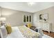 Bedroom with a view of the backyard, with a white dresser, and gray bench at the end of the bed at 623 Totten Pl, Chapel Hill, NC 27514
