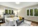 Cozy main bedroom featuring large windows and a stylish bed and bench at 623 Totten Pl, Chapel Hill, NC 27514