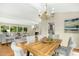 Open floorplan featuring a dining area with table and view of living room and a cozy fireplace at 623 Totten Pl, Chapel Hill, NC 27514