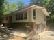 Exterior of the house featuring a brick foundation, a patio, and a multi-pane windows at 623 Totten Pl, Chapel Hill, NC 27514