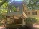 View of the back exterior of the house, showcasing the deck, brick foundation, and access to the yard at 623 Totten Pl, Chapel Hill, NC 27514