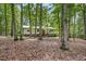 Traditional home showcasing natural landscaping surrounded by lush trees at 623 Totten Pl, Chapel Hill, NC 27514