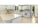 Traditional white kitchen featuring a tile backsplash and modern appliances at 623 Totten Pl, Chapel Hill, NC 27514
