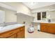 Functional laundry room with a sink, storage cabinets, and ample counter space for folding at 623 Totten Pl, Chapel Hill, NC 27514