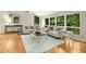 Bright living room featuring hardwood floors, modern sofas and large windows at 623 Totten Pl, Chapel Hill, NC 27514
