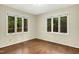 Neutral room featuring hardwood floors with natural light from large windows at 623 Totten Pl, Chapel Hill, NC 27514