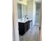 Bathroom vanity featuring a white countertop, dark wood cabinets, and a full mirror at 644 Wall Rd, Wendell, NC 27591