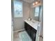 Bathroom vanity with a white countertop, dark wood cabinets, a mirror, and a window with decorative shades at 644 Wall Rd, Wendell, NC 27591