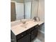 Bathroom vanity with a white countertop, dark wood cabinets, a mirror, and a decorative shelf at 644 Wall Rd, Wendell, NC 27591