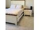 Bedroom features a white bed frame, patterned bedding, and a matching nightstand, offering comfort and style at 644 Wall Rd, Wendell, NC 27591