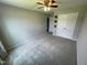 Bright bedroom with neutral walls, plush carpeting, and a double door closet at 644 Wall Rd, Wendell, NC 27591