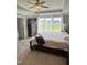 Bedroom with tray ceilings, carpet, a window view, and neutral paint at 644 Wall Rd, Wendell, NC 27591