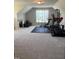 Bonus room has neutral carpet and a variety of exercise equipment, perfect for a workout space at 644 Wall Rd, Wendell, NC 27591