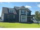 Two-story home with dark siding, a gray shingled roof, manicured lawn, and manicured shrubs at the foundation at 644 Wall Rd, Wendell, NC 27591