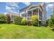 Lush backyard featuring a screened porch, well-manicured lawn, and professional landscaping at 664 Old Dairy Dr, Wake Forest, NC 27587