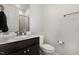 Bathroom with a dark wood vanity, granite countertop, and a modern faucet at 664 Old Dairy Dr, Wake Forest, NC 27587
