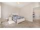 Bedroom featuring soft carpet, a patterned bed, and an adjacent room at 664 Old Dairy Dr, Wake Forest, NC 27587