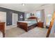 This bedroom features a wooden bed frame and soft, neutral carpet that enhances the space's warmth at 664 Old Dairy Dr, Wake Forest, NC 27587