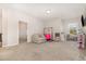 Spacious bonus room with neutral carpet, offers versatility for a playroom or entertainment area at 664 Old Dairy Dr, Wake Forest, NC 27587