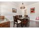 Formal dining room featuring dark wood table, bench, and decorative light fixture at 664 Old Dairy Dr, Wake Forest, NC 27587