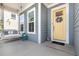 Inviting front porch featuring a cozy swing, complemented by stylish decor and a vibrant yellow front door at 664 Old Dairy Dr, Wake Forest, NC 27587