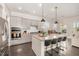 Kitchen with an island, stainless steel appliances, and gray cabinetry at 664 Old Dairy Dr, Wake Forest, NC 27587