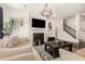 Inviting living room featuring a shiplap fireplace, dark hardwood floors, and a staircase leading to the upper level at 664 Old Dairy Dr, Wake Forest, NC 27587
