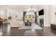 Bright and spacious living room with large windows, a cozy fireplace, and modern furnishings, perfect for relaxation at 664 Old Dairy Dr, Wake Forest, NC 27587