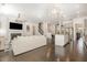 Open concept living space with fireplace, kitchen island, modern light fixtures, and stairs to the upper level at 664 Old Dairy Dr, Wake Forest, NC 27587