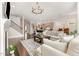 Open-concept living space with views of the kitchen, fireplace, staircase, and stylish light fixtures at 664 Old Dairy Dr, Wake Forest, NC 27587